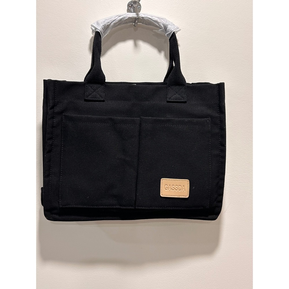 Black canvas bag featuring a brown leather brand tag branded "GASSDA".